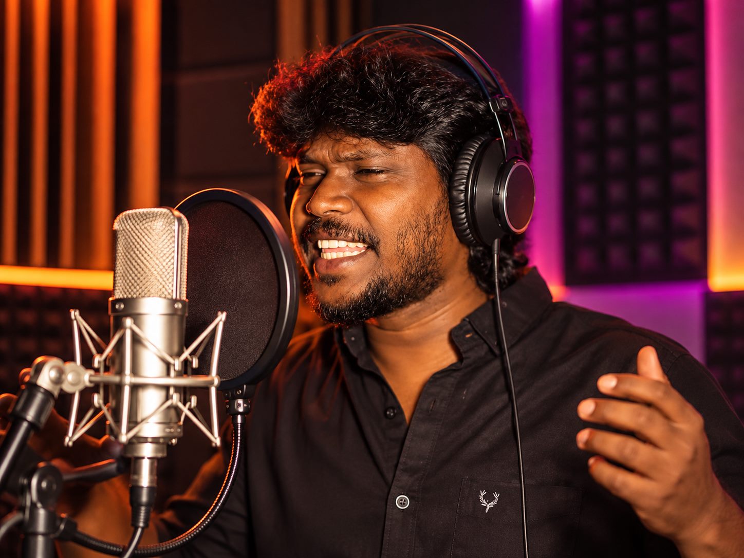 Singer delivering a vocal performance in the booth